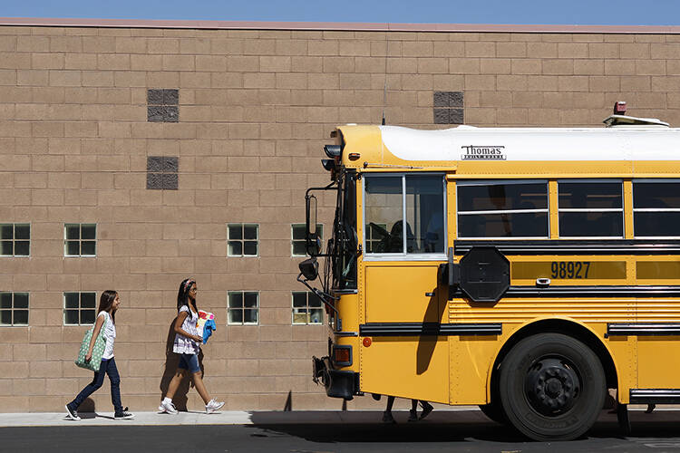 File - A school bus idles in the parking lot of the Mabel Hoggard Elementary School on Tuesday, ...