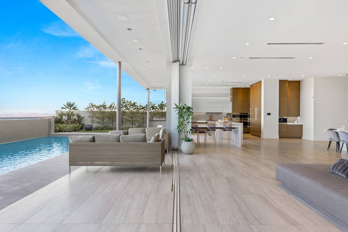 Large format porcelain tile flooring flows from inside the home to outdoors. (Ivan Sher Group)