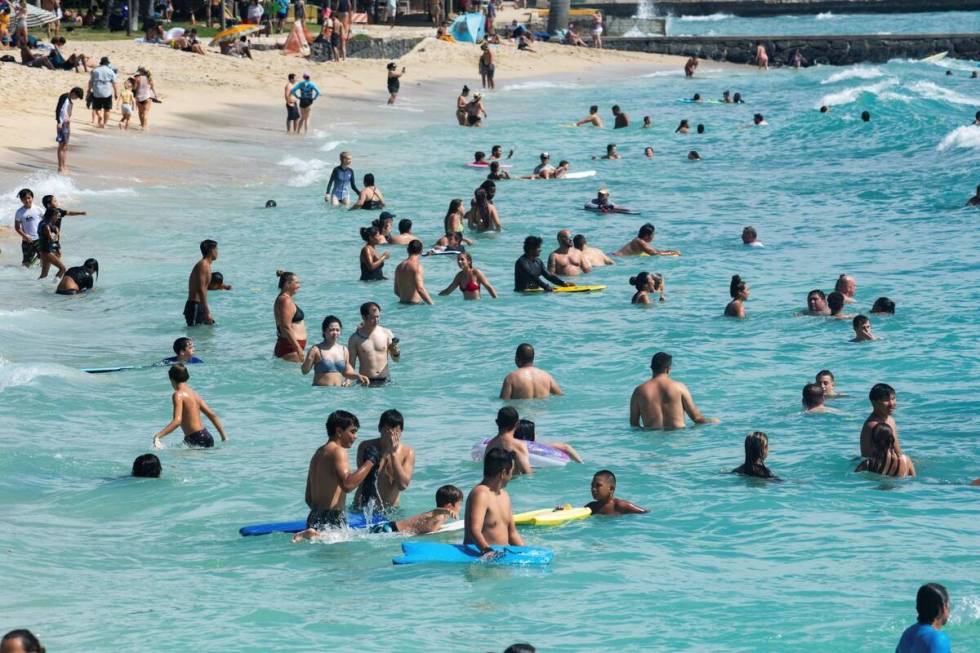 Swimmers, boogie boarders and surfers made good good use high swells in Waikiki, Hawaii, Sunday ...