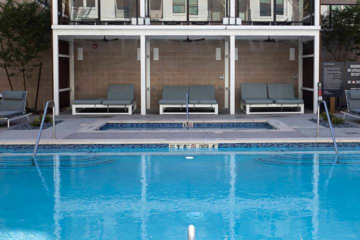 Swimming pool area at Auric Symphony Park, the first luxury multifamily residential community a ...