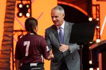 MLB Commissioner Rob Manfred, right, shakes hands with Willa suarez, of Uvalde, Tex., during th ...