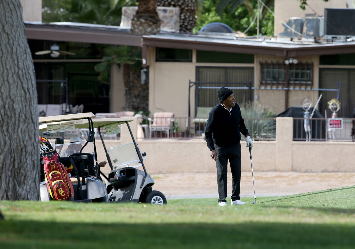 O.J. Simpson watches his ball roll onto the green at the seventh hole at Las Vegas National Gol ...