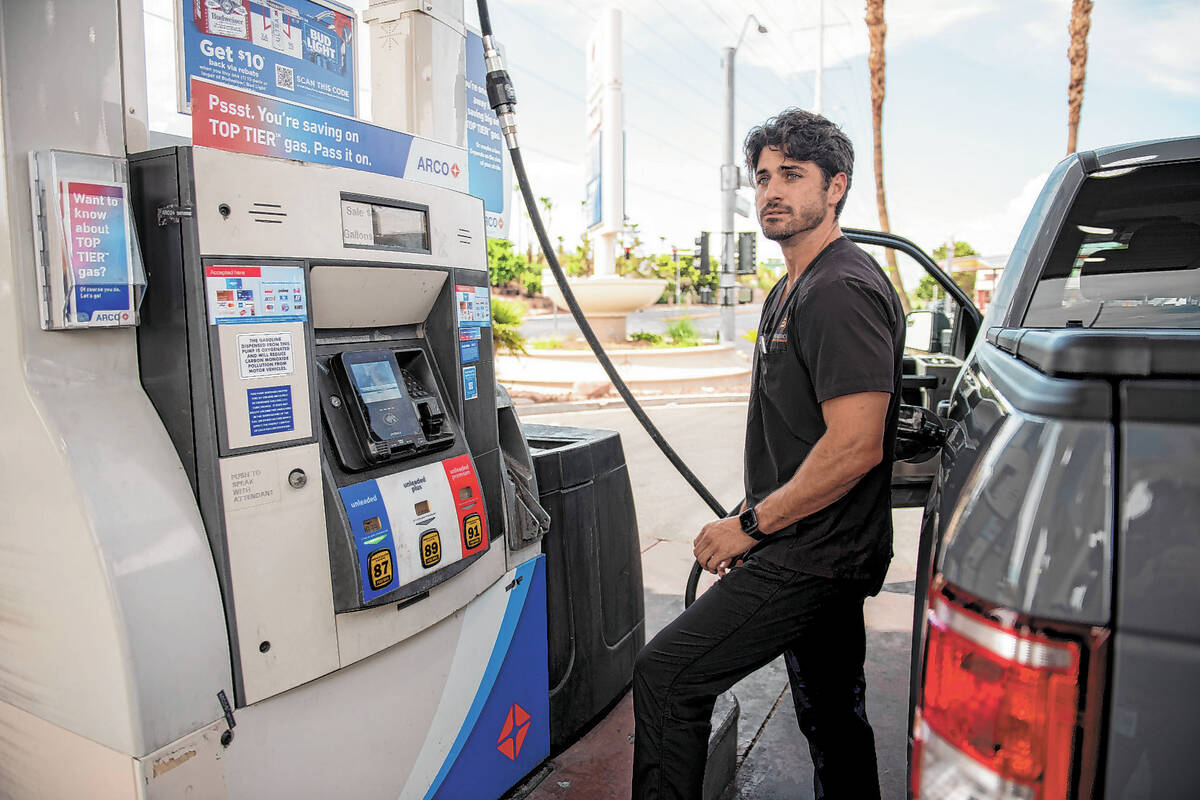 Zachary Kinney pumps gas at an Arco station on West Sahara Ave. on Wednesday, July 20, 2022, in ...