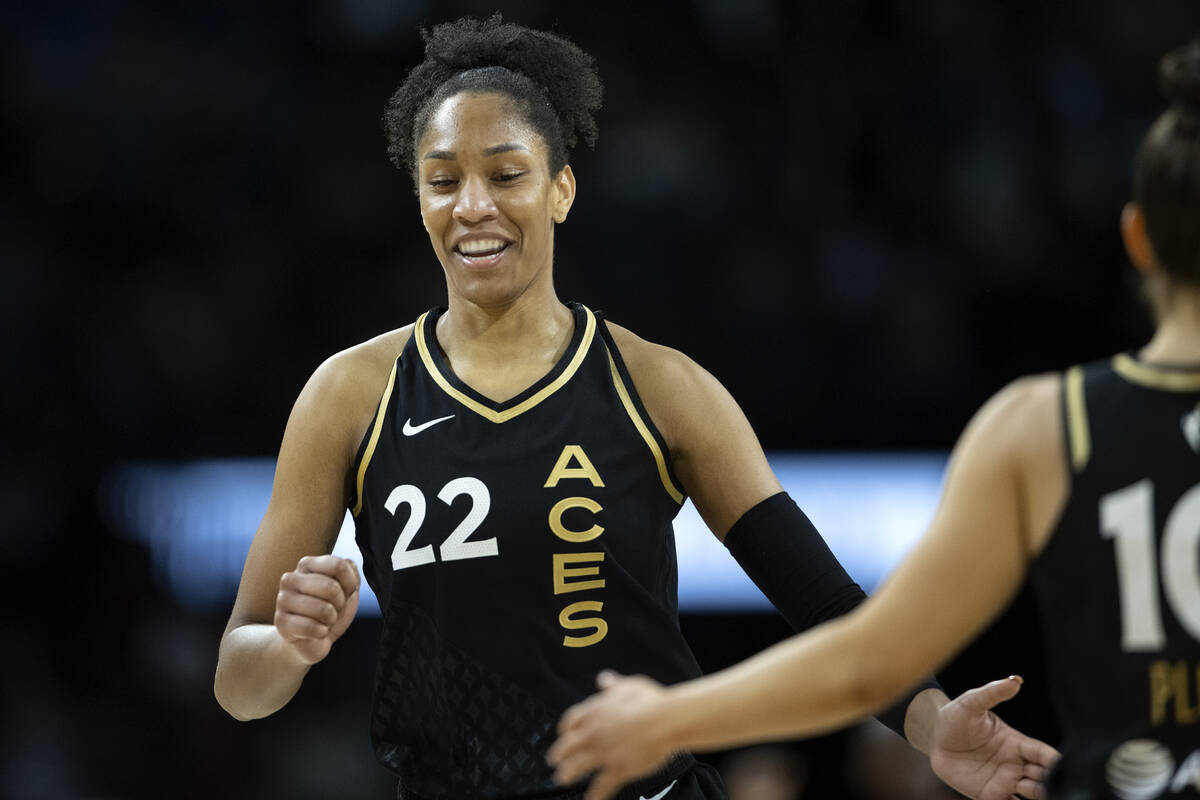 Las Vegas Aces forward A'ja Wilson (22) slaps hands with guard Kelsey Plum (10) during the firs ...