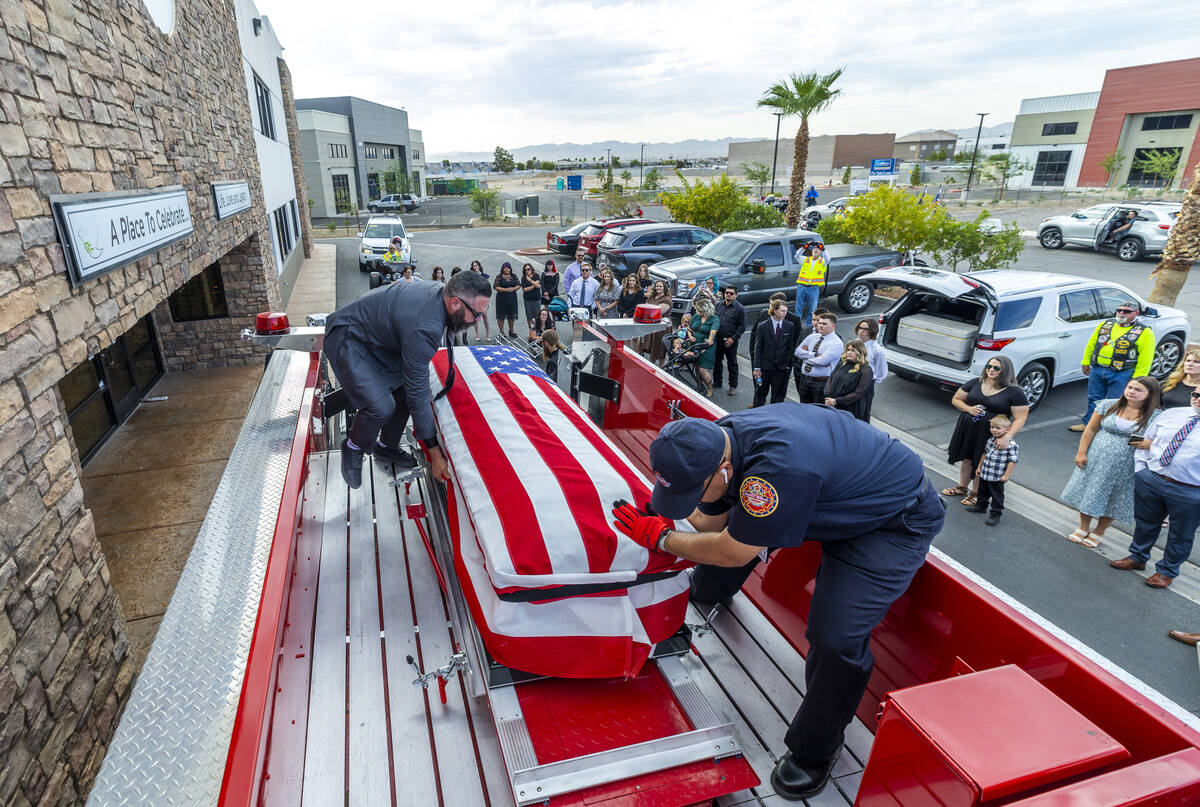 (From left) Kevin Egbert and Frank Pizarro secure the casket of Las Vegas Fire & Rescue Cap ...