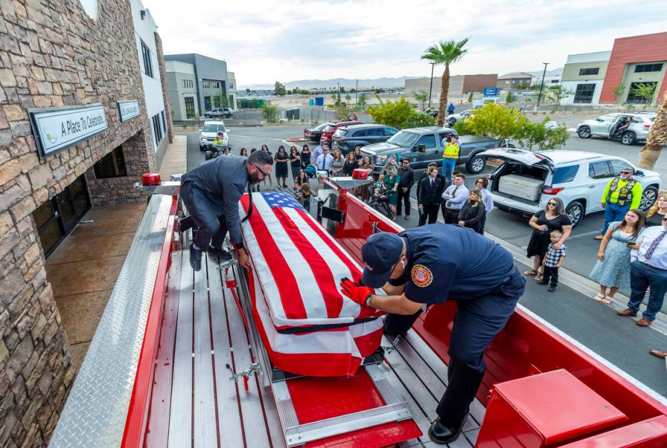 (From left) Kevin Egbert and Frank Pizarro secure the casket of Las Vegas Fire & Rescue Cap ...