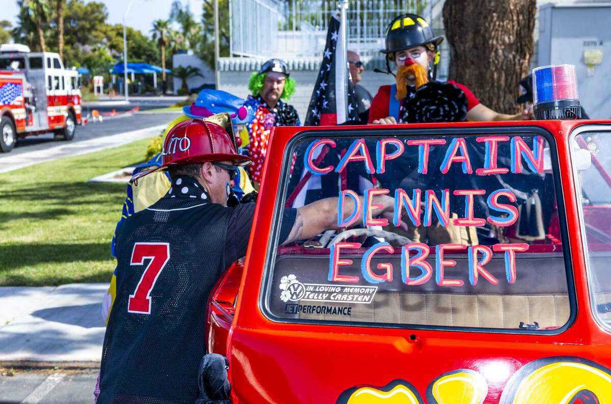 The Las Vegas Fire Clowns gather near the Raymond J. Pfeifer Memorial Caisson, left, on its mai ...