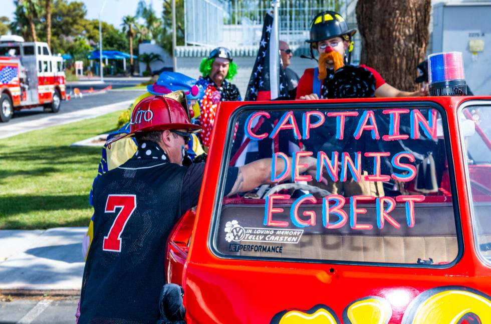 The Las Vegas Fire Clowns gather near the Raymond J. Pfeifer Memorial Caisson, left, on its mai ...