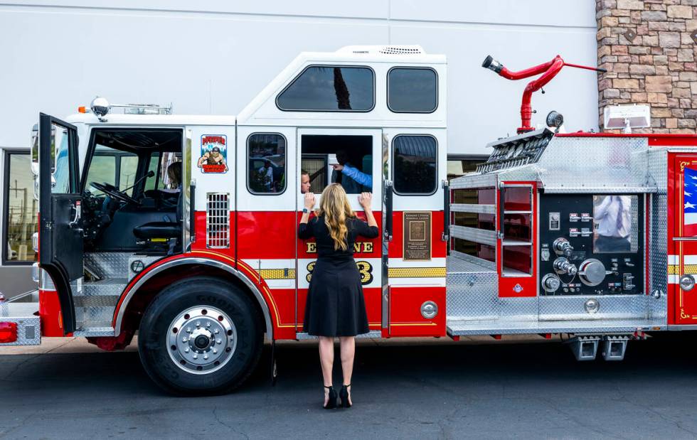 A mom checks on kids who get to ride in the Raymond J. Pfeifer Memorial Caisson on its maiden m ...