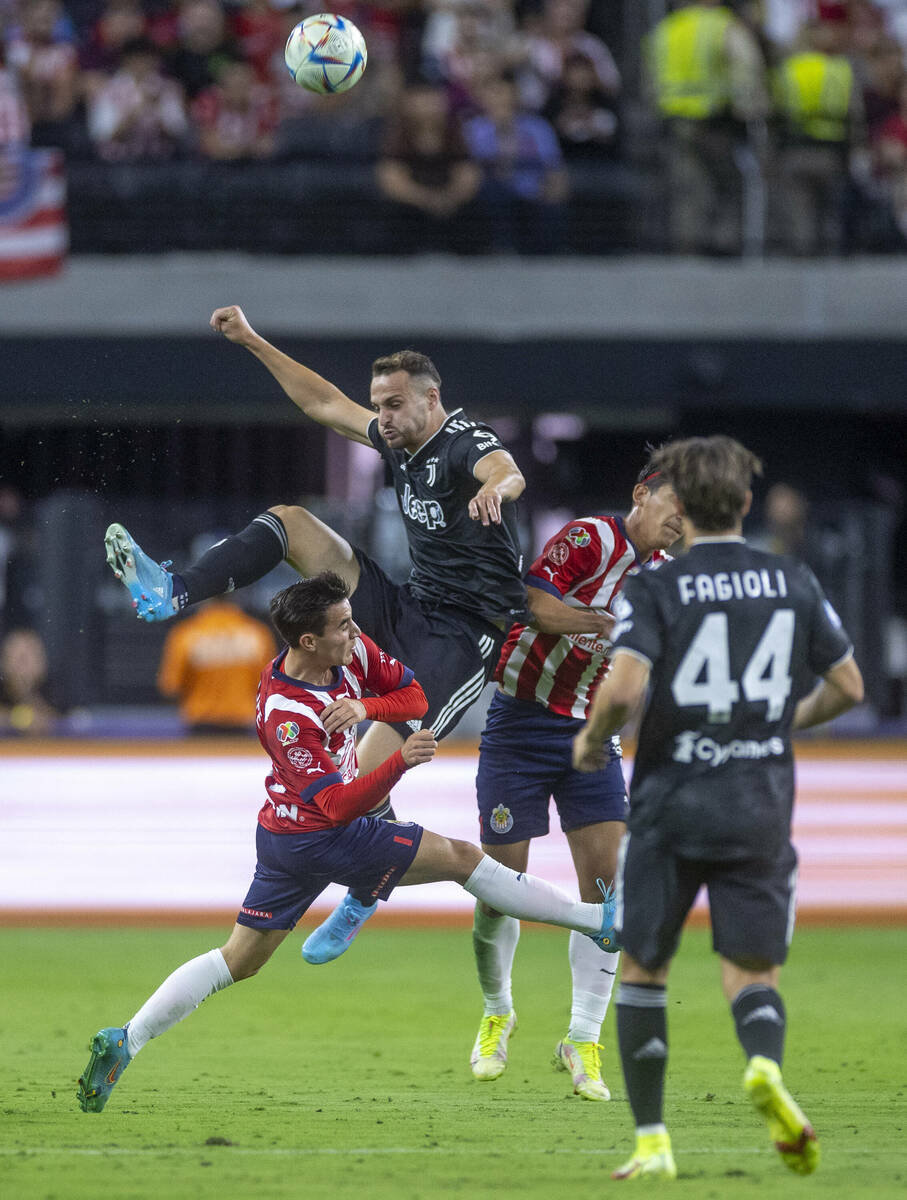 Chivas Guadalajara and Juventus players collide on the field advancing the ball during the firs ...