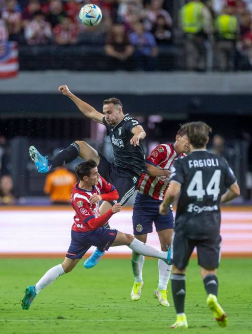 Chivas Guadalajara and Juventus players collide on the field advancing the ball during the firs ...