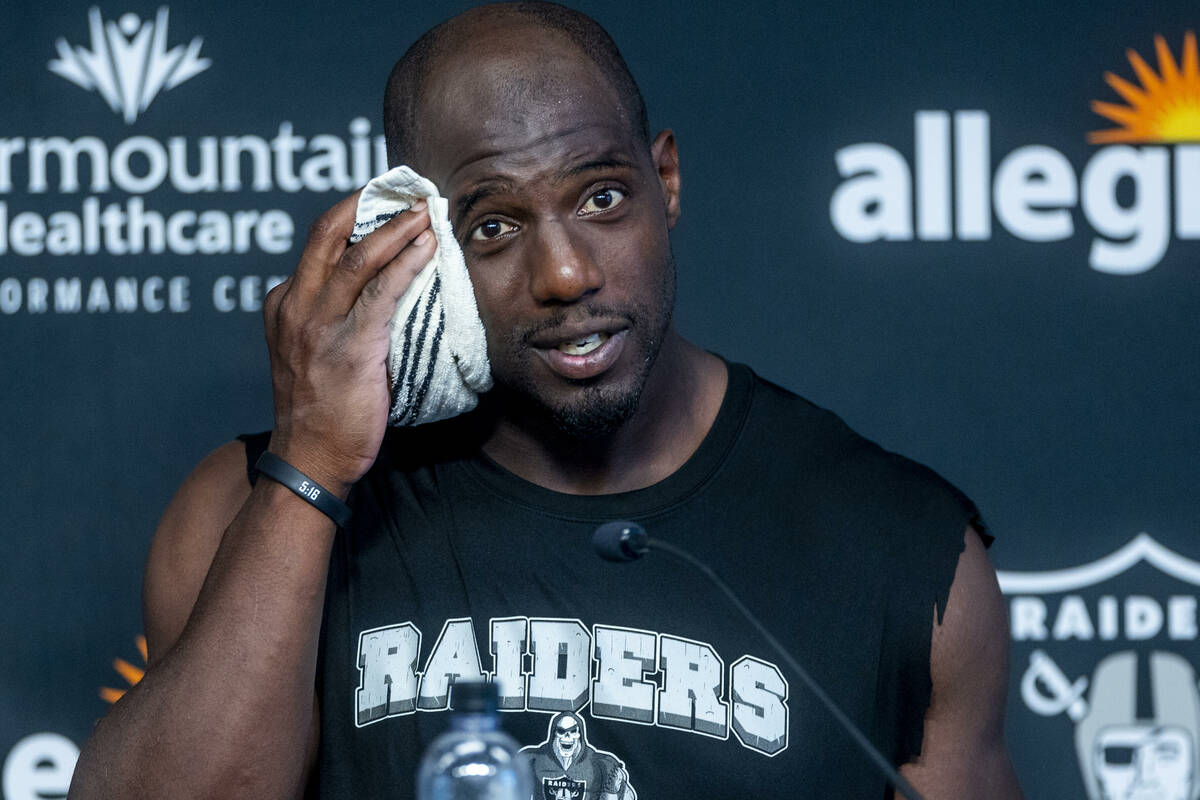 Safety Duron Harmon towels off in a press conference during the Raiders first practice at train ...