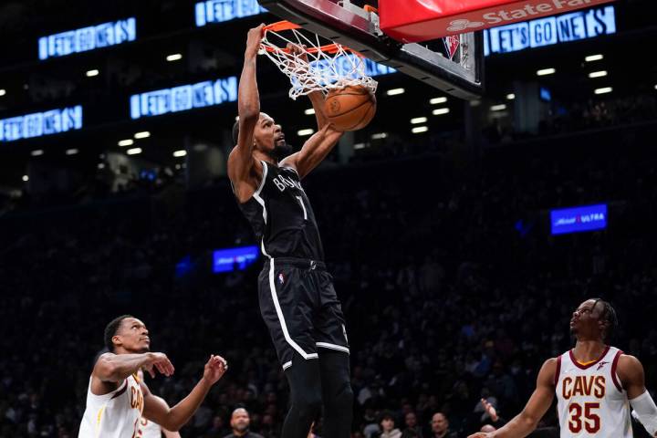 FILE -B rooklyn Nets' Kevin Durant dunks the ball during the second half of the opening basketb ...