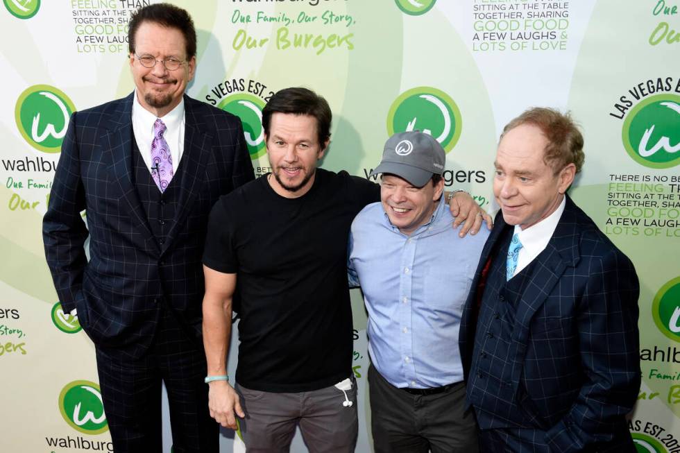 Penn Jillette, Mark Wahlberg, Paul Wahlberg and Teller pose for photos as they arrive at a VIP ...