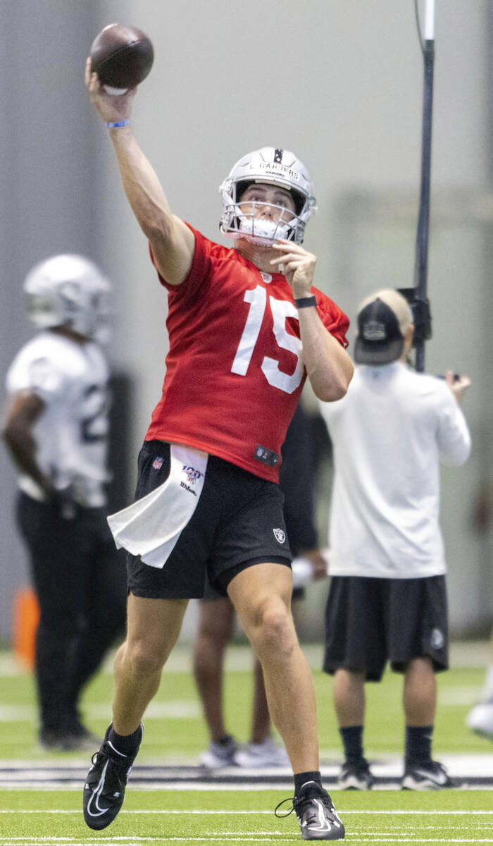 Raiders quarterback Chase Garbers (15) throws a pass during the team’s training camp pra ...
