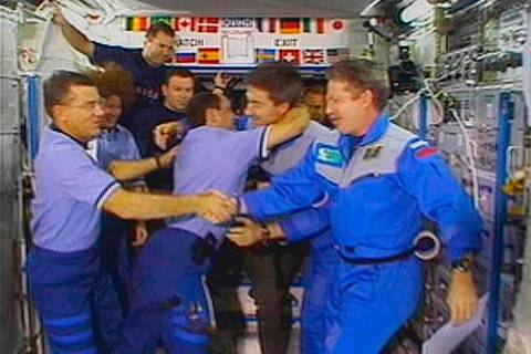 FILE - Astronaut James Voss, far left, shakes hands with astronaut Bill Shepherd, far right, as ...
