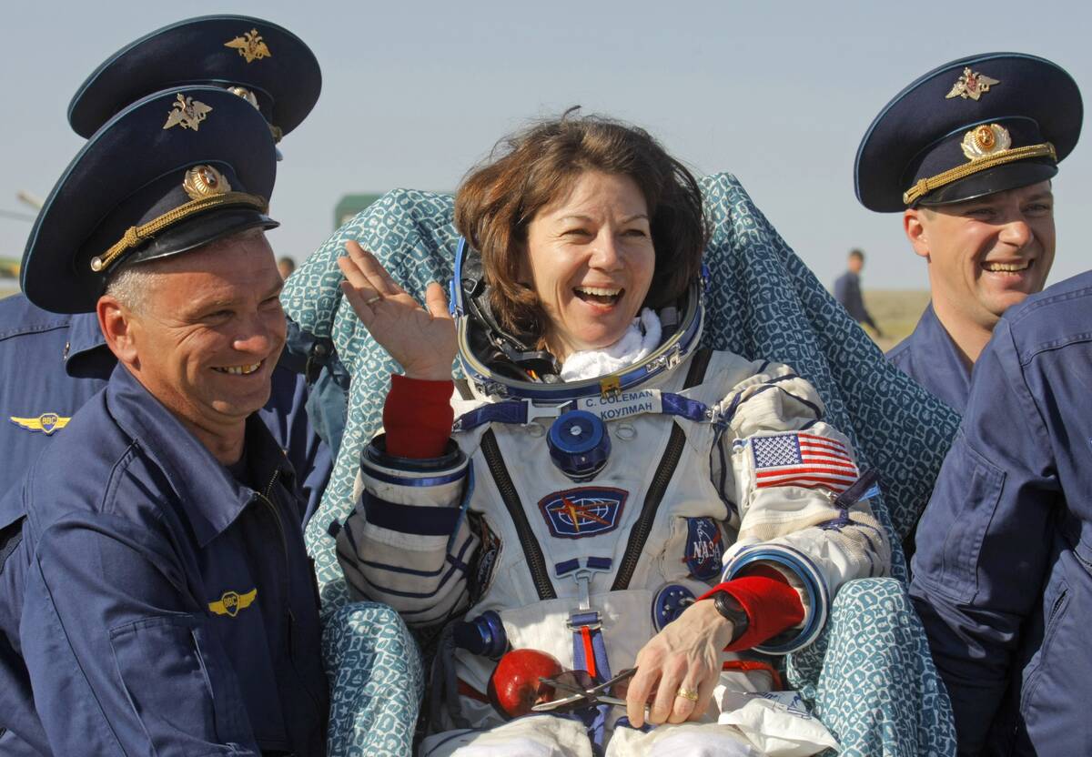 FILE - Russian space agency rescue team members carry U.S. astronaut Cady Coleman away from the ...