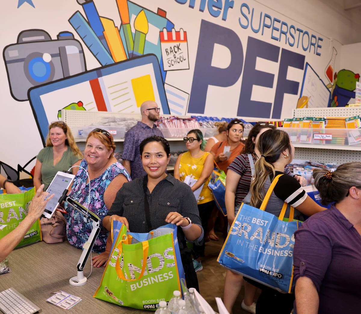 Ethelene Robles, a kindergarten teacher at Dickens Elementary, center, shops at the newest The ...