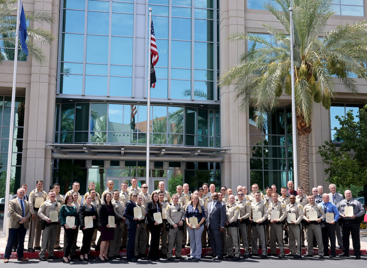 Las Vegas police officers and other award recipients pose for a photo after a commendation cere ...