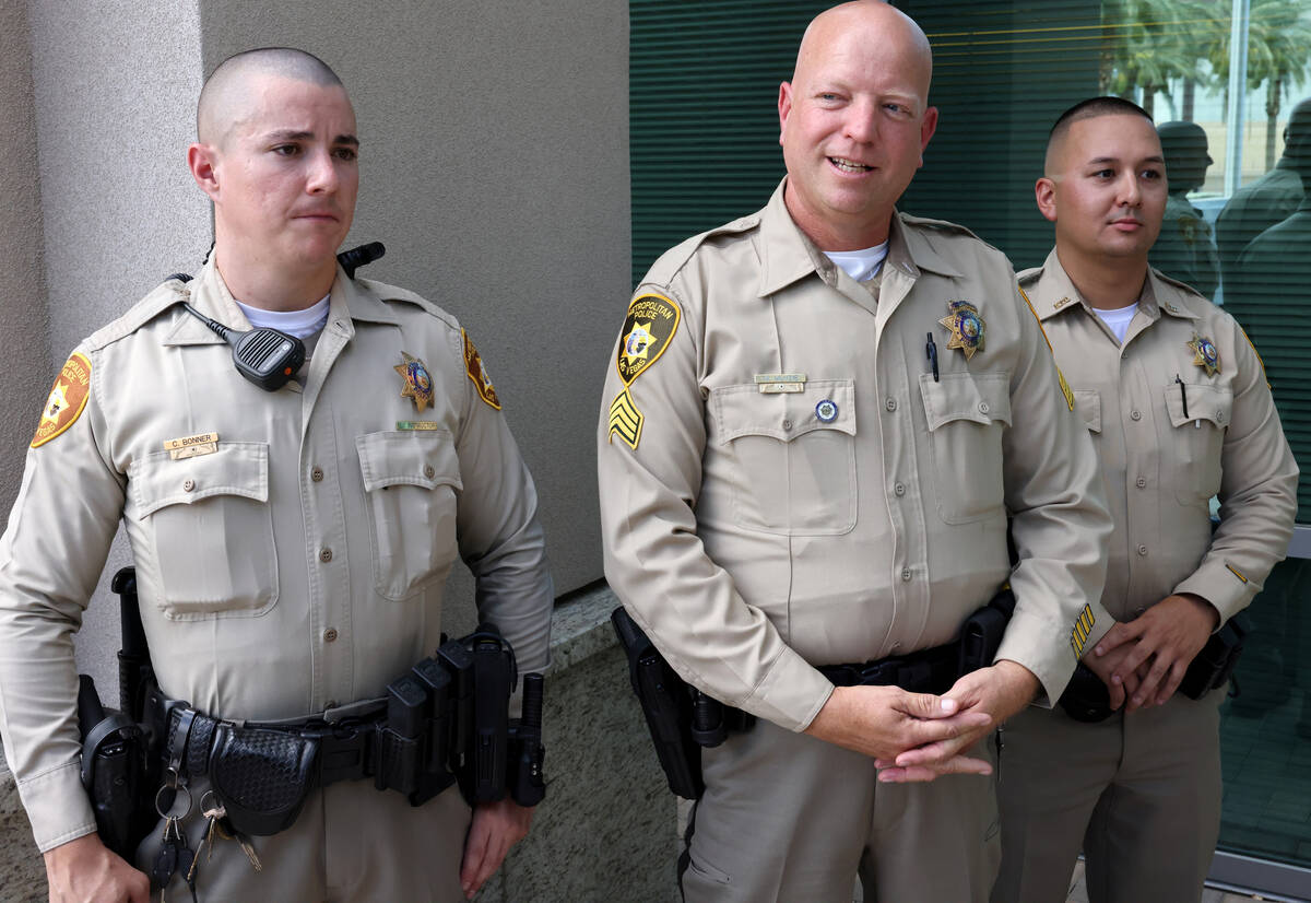 Las Vegas police officer Cody Bonner, from left, Sgt. Mark Menzie and officer Leon Chavez talk ...