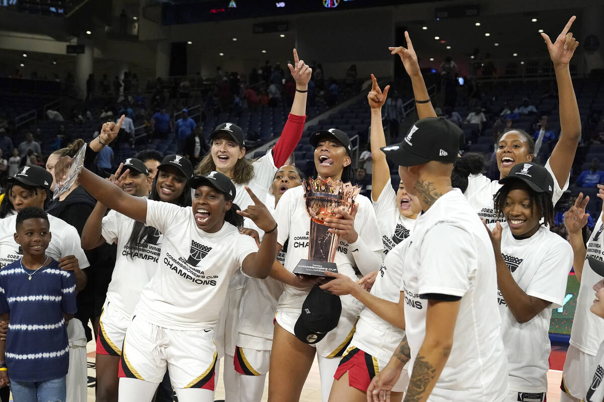 The Las Vegas Aces celebrate with the Commissioner's Cup after defeating the Chicago Sky 93-83 ...