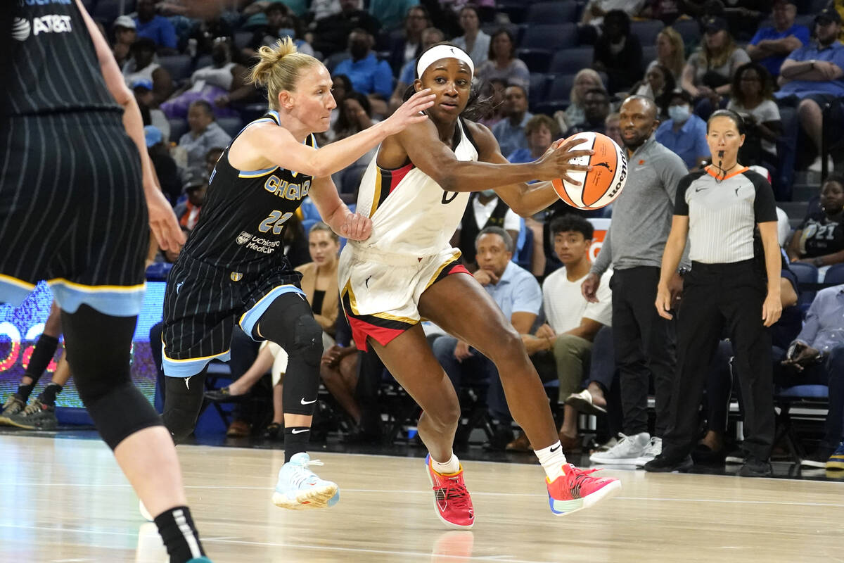 Las Vegas Aces' Jackie Young (0) drives to the basket past Chicago Sky's Courtney Vandersloot d ...