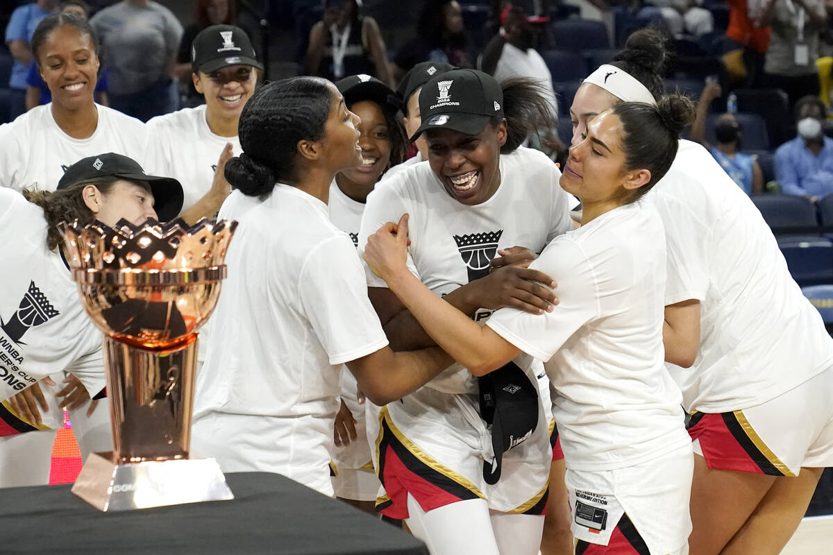Las Vegas Aces' Chelsea Gray, center, is mobbed by her teammates as she is named MVP of the WNB ...