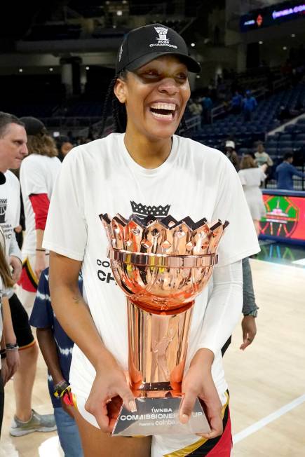 Las Vegas Aces' A'ja Wilson carries the WNBA Commissioner's Cup after the Aces defeated the Chi ...