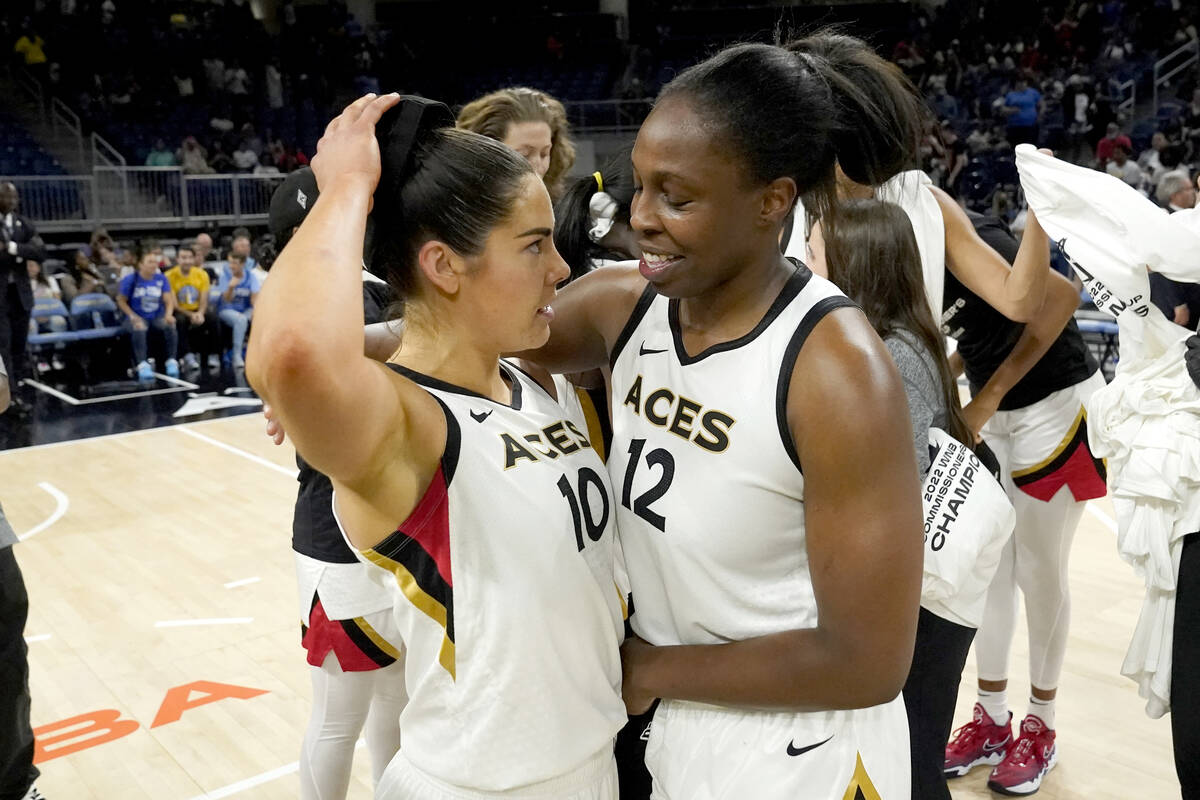 Las Vegas Aces' Chelsea Gray (12) and Kelsey Plum hug after their team beat the Chicago Sky 93- ...