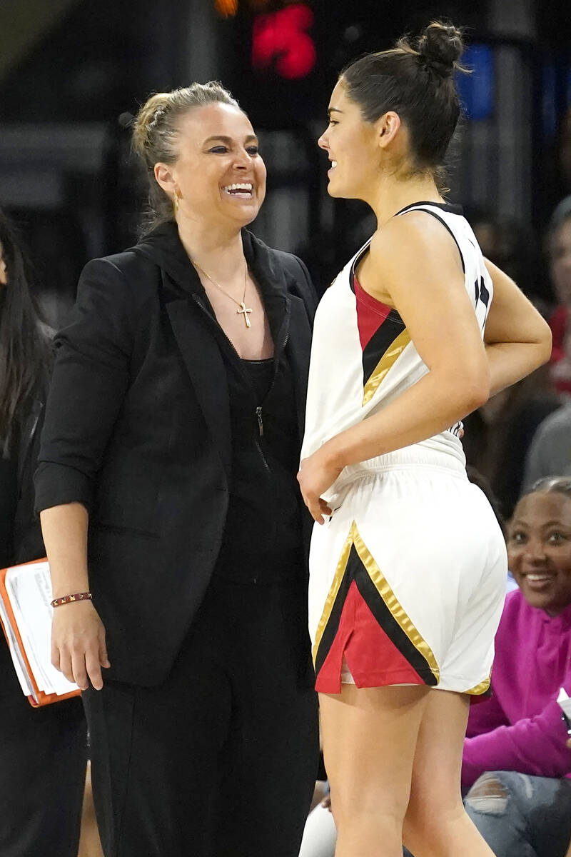 Las Vegas Aces head coach Becky Hammon, left, smiles with guard Kelsey Plum late in the second ...