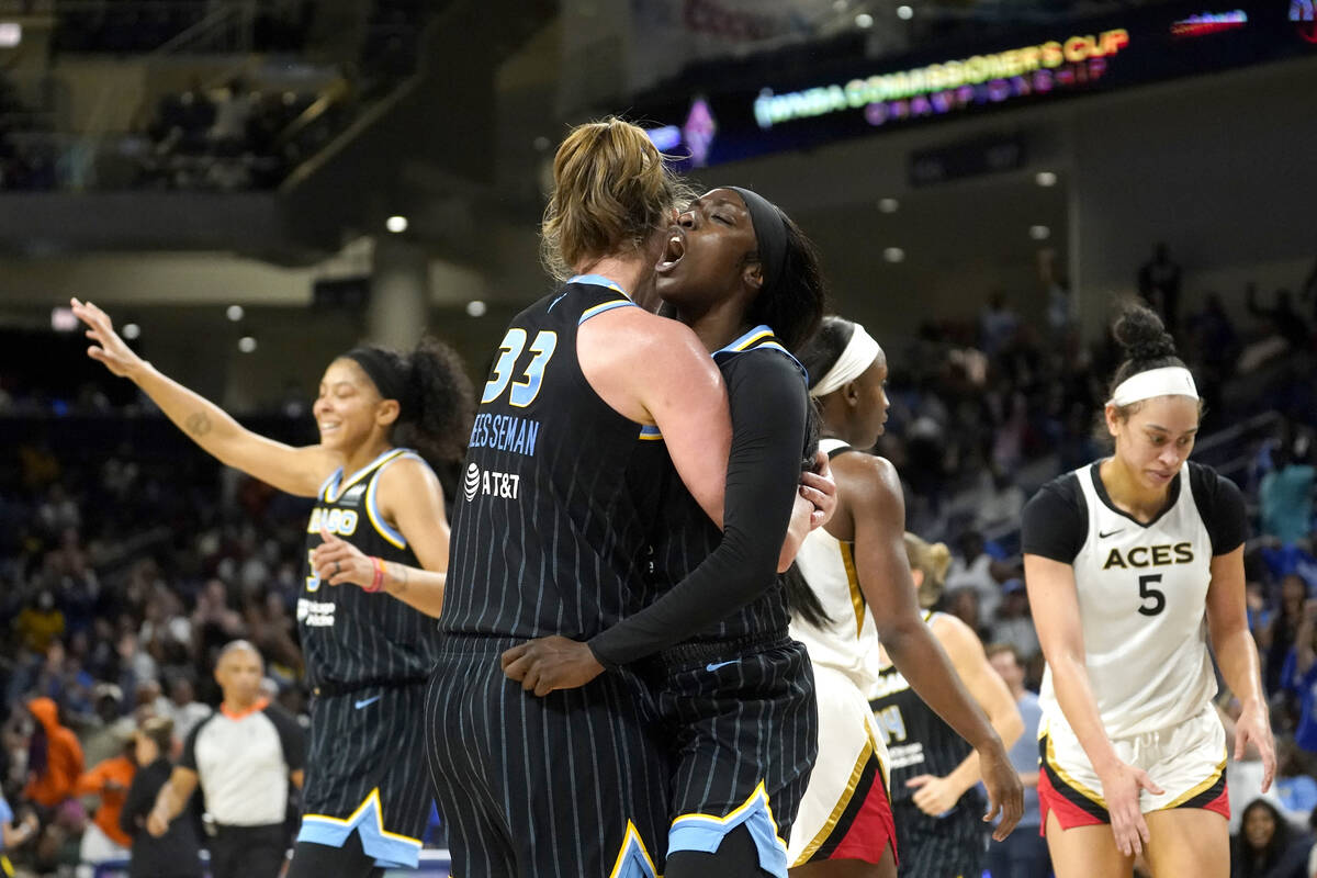 Chicago Sky's Emma Meesseman (33) hugs Kahleah Copper as she yells out after scoring a drawing ...