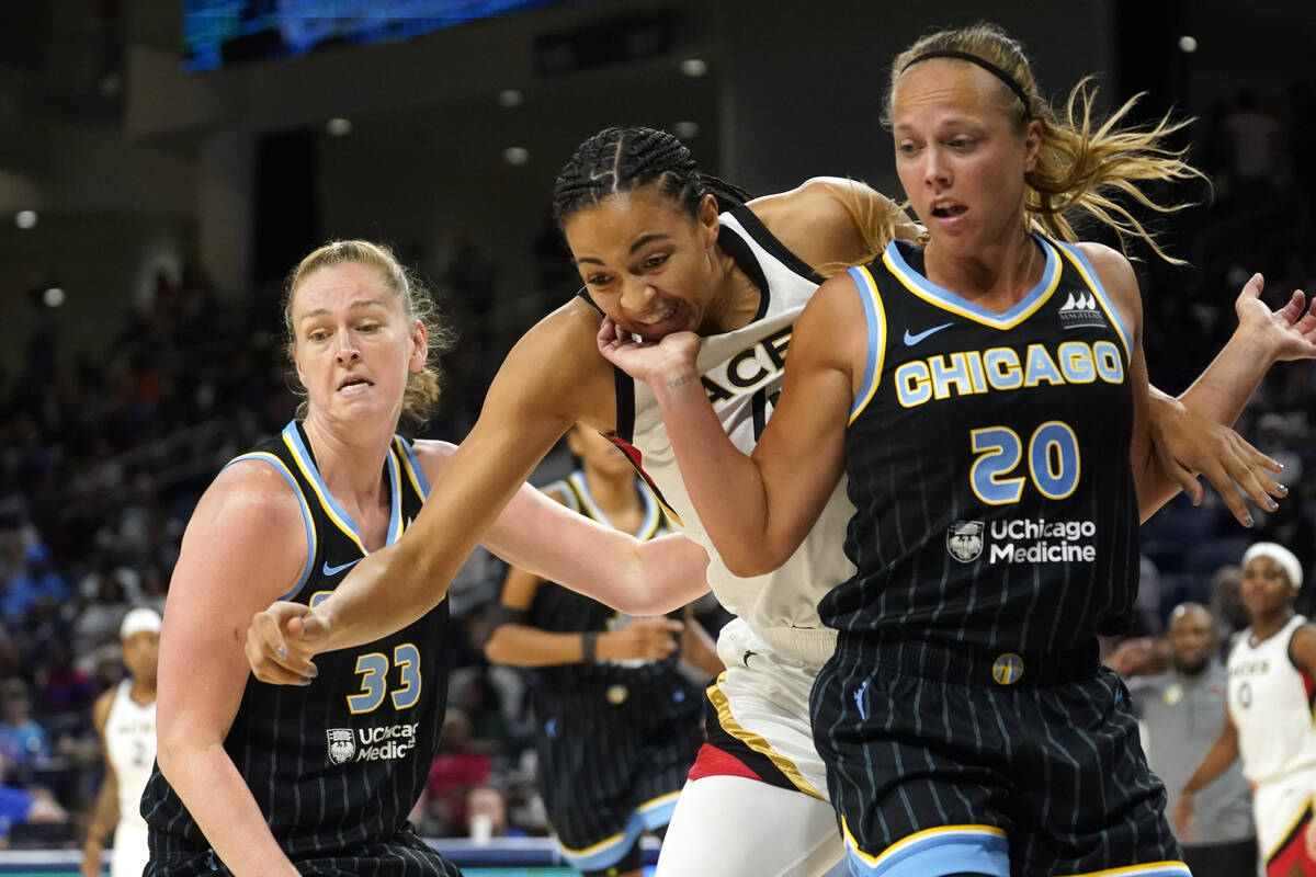 Chicago Sky's Julie Allemand (20) blocks out Las Vegas Aces' Kiah Stokes for a loose ball as te ...
