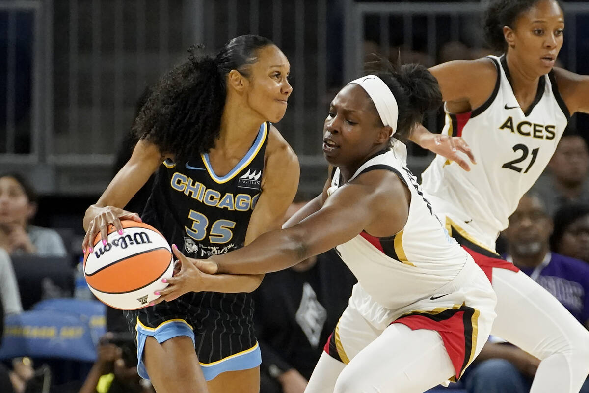 Las Vegas Aces' Chelsea Gray, right, pressures Chicago Sky's Rebekah Gardner during the first h ...