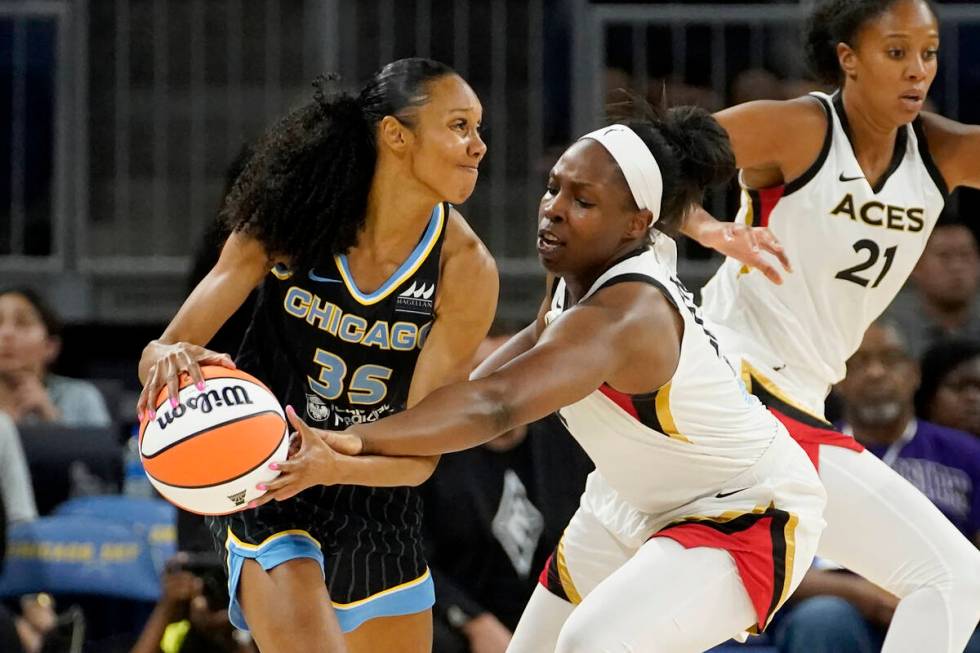 Las Vegas Aces' Chelsea Gray, right, pressures Chicago Sky's Rebekah Gardner during the first h ...