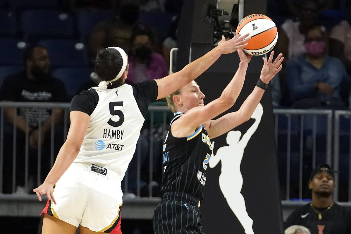 Las Vegas Aces' Dearica Hamby (5) blocks the pass of Chicago Sky's Courtney Vandersloot during ...