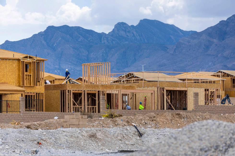 Workers complete framing and walls on new home construction about Skye Canyon on Wednesday, Jul ...