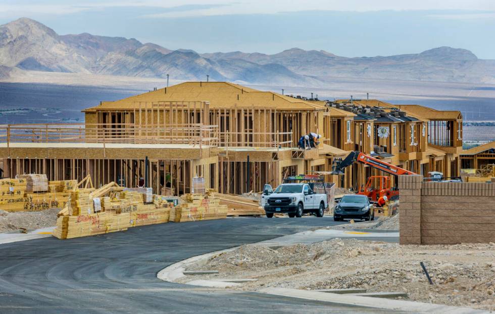 Workers complete framing and walls on new home construction about Skye Canyon on Wednesday, Jul ...