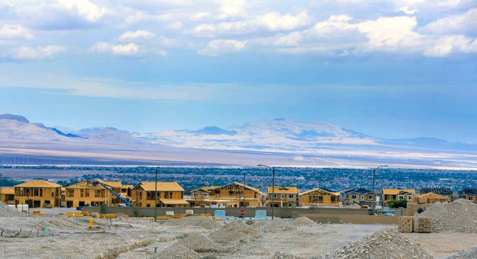 Workers complete framing and walls on new home construction about Skye Canyon on Wednesday, Jul ...