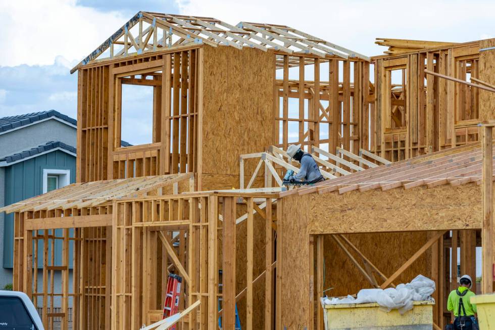 Workers complete framing on new home construction about Skye Canyon on Wednesday, July 27, 2022 ...