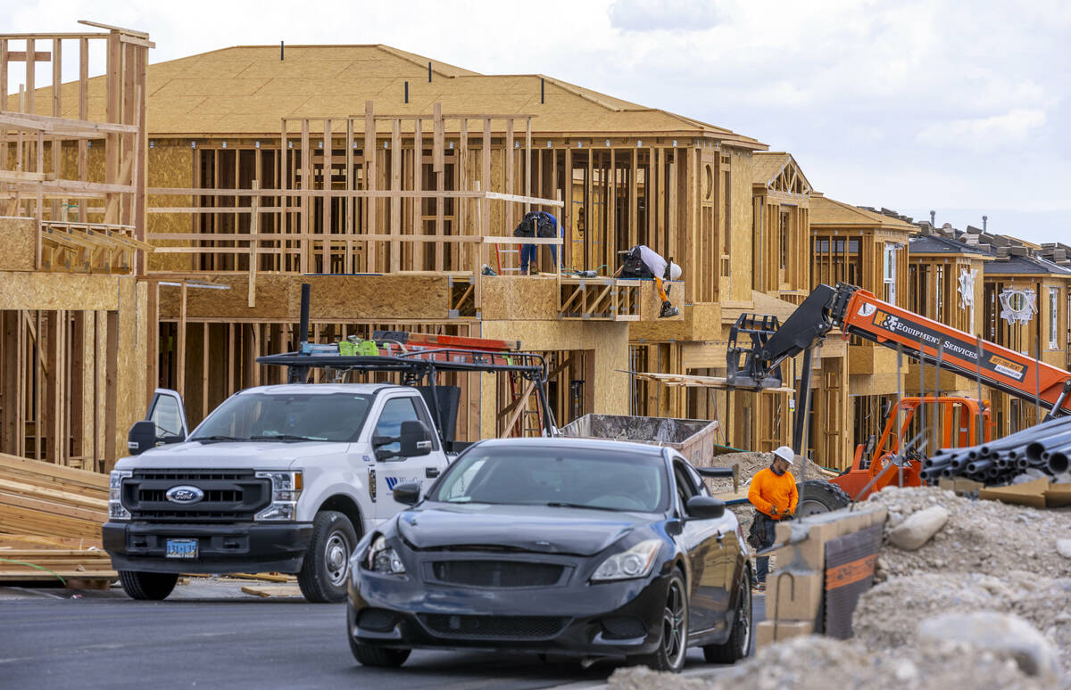 Workers complete framing and walls on new home construction about Skye Canyon on Wednesday, Jul ...