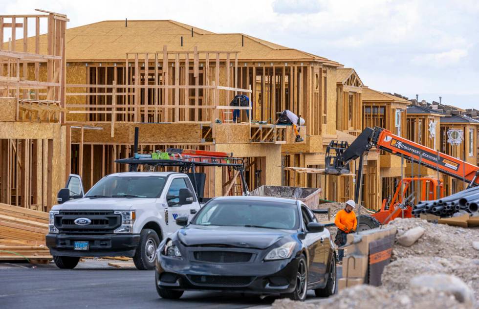 Workers complete framing and walls on new home construction about Skye Canyon on Wednesday, Jul ...