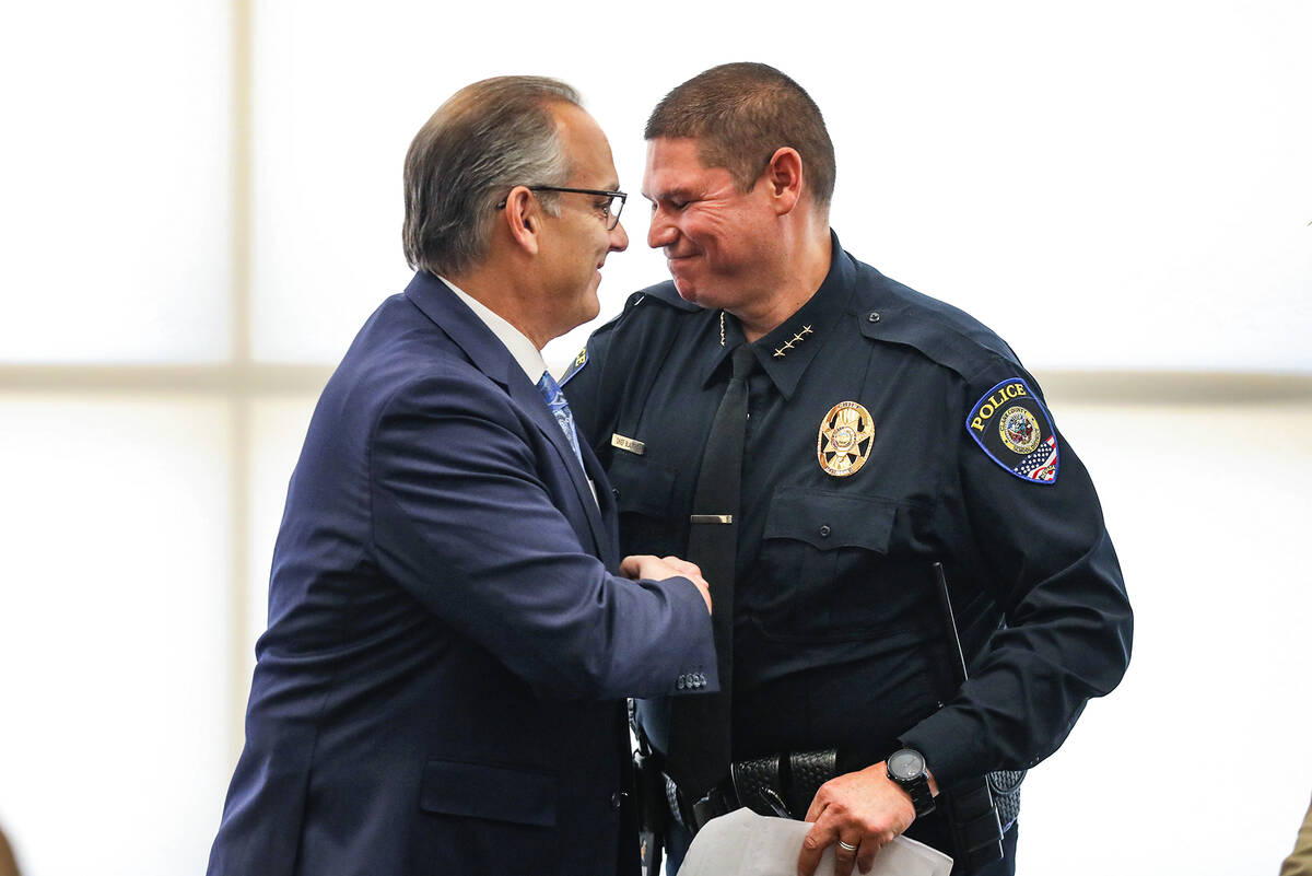 Superintendent Dr. Jesus Jara, left, shakes hands with Clark County School District Police Chie ...
