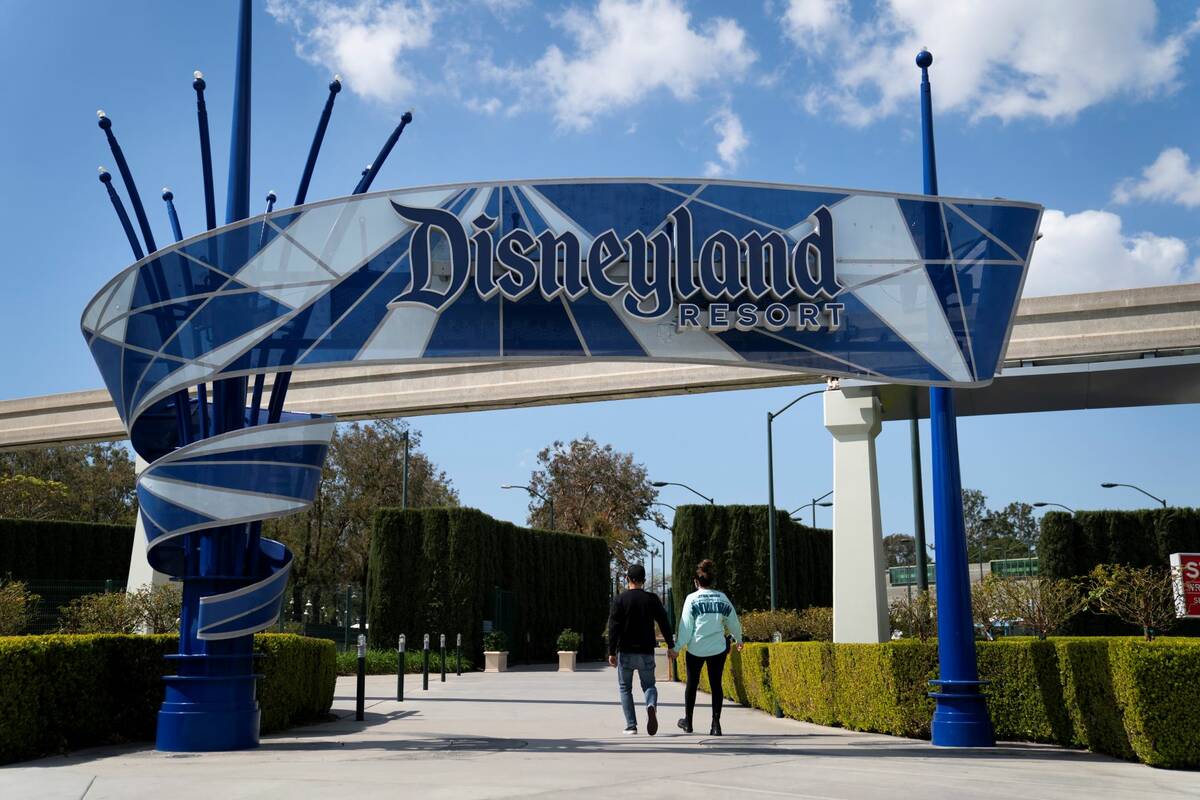 Visitors enter Disneyland Resort in Anaheim, Calif., in March 2021. (AP Photo/Jae C. Hong)