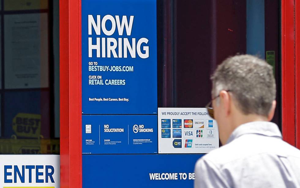 In this Monday, May 22, 2017, photo, a "Now Hiring" sign welcomes a customer entering ...