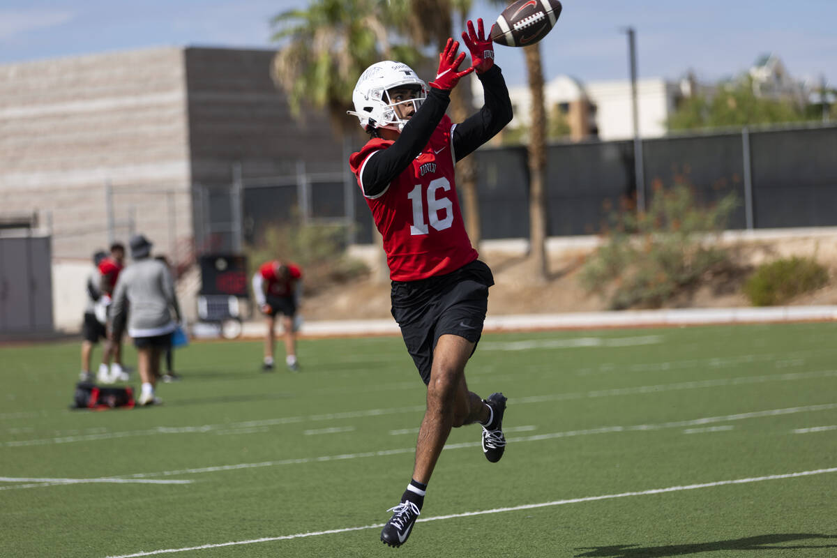 UNLV's Calvin Sounders (16) reaches for the ball for a catch during a team football practice at ...