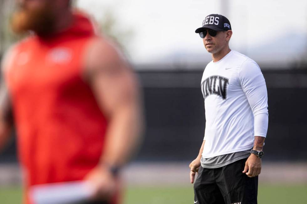 UNLV's football head coach Marcus Arroyo watches his players run drills during a team practice ...