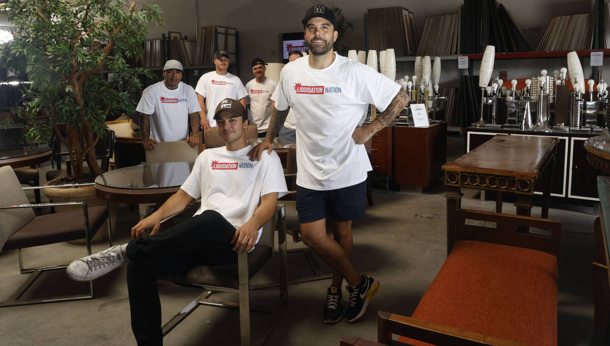 Franky Perez, owner of Liquidation Nation, a furniture store, right, poses for a photo, Saturda ...