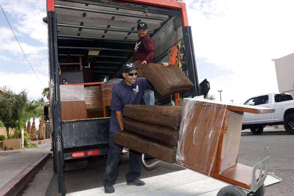 Jose Pacheco, foreground, and Martin Perez, background, of Errands 4 You deliver the furniture ...