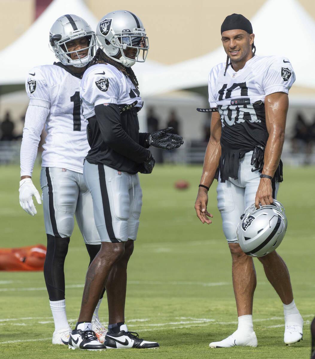 Raiders wide receivers Demarcus Robinson (11), Davante Adams (17) and Mack Hollins (10) regroup ...