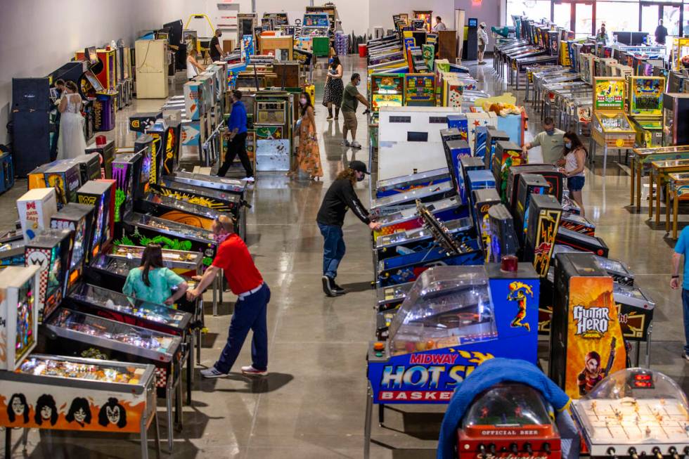 Customers enjoy playing some of the hundreds of games as the Pinball Hall of Fame is in their n ...